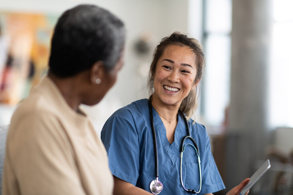 A Dr. and patient having a pleasant discussion.