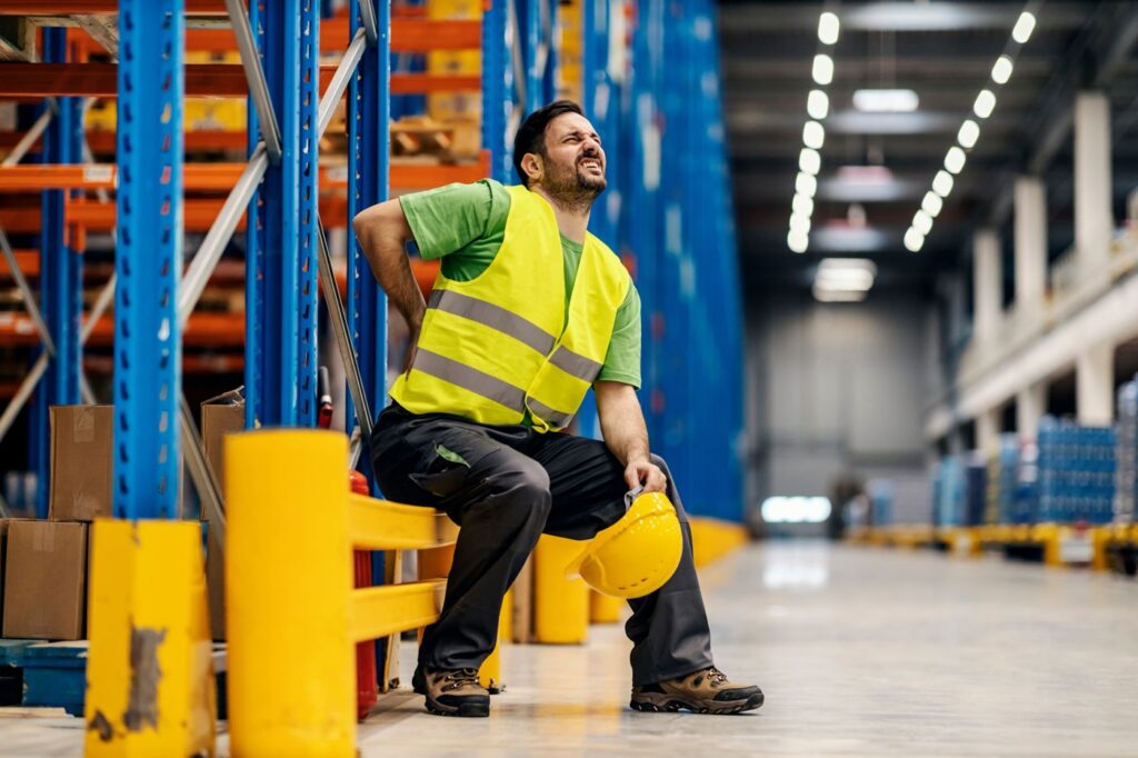 Warehouse worker with a back injury from lifting on the job